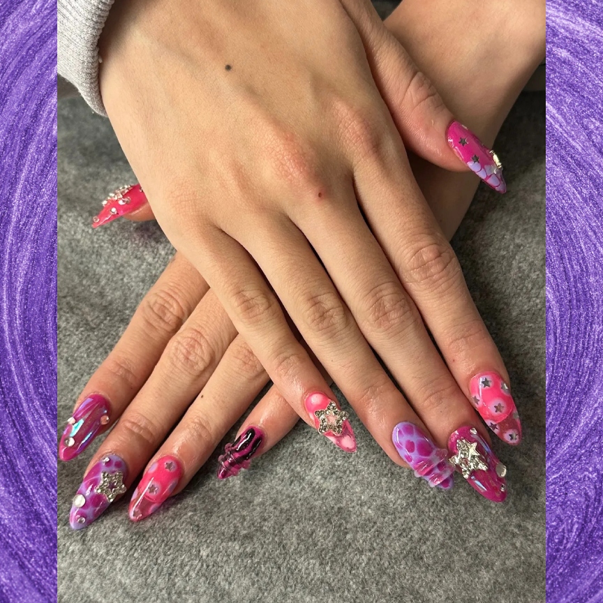 a pink and purple manicure on a purple background