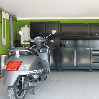 garage with green wall and moped