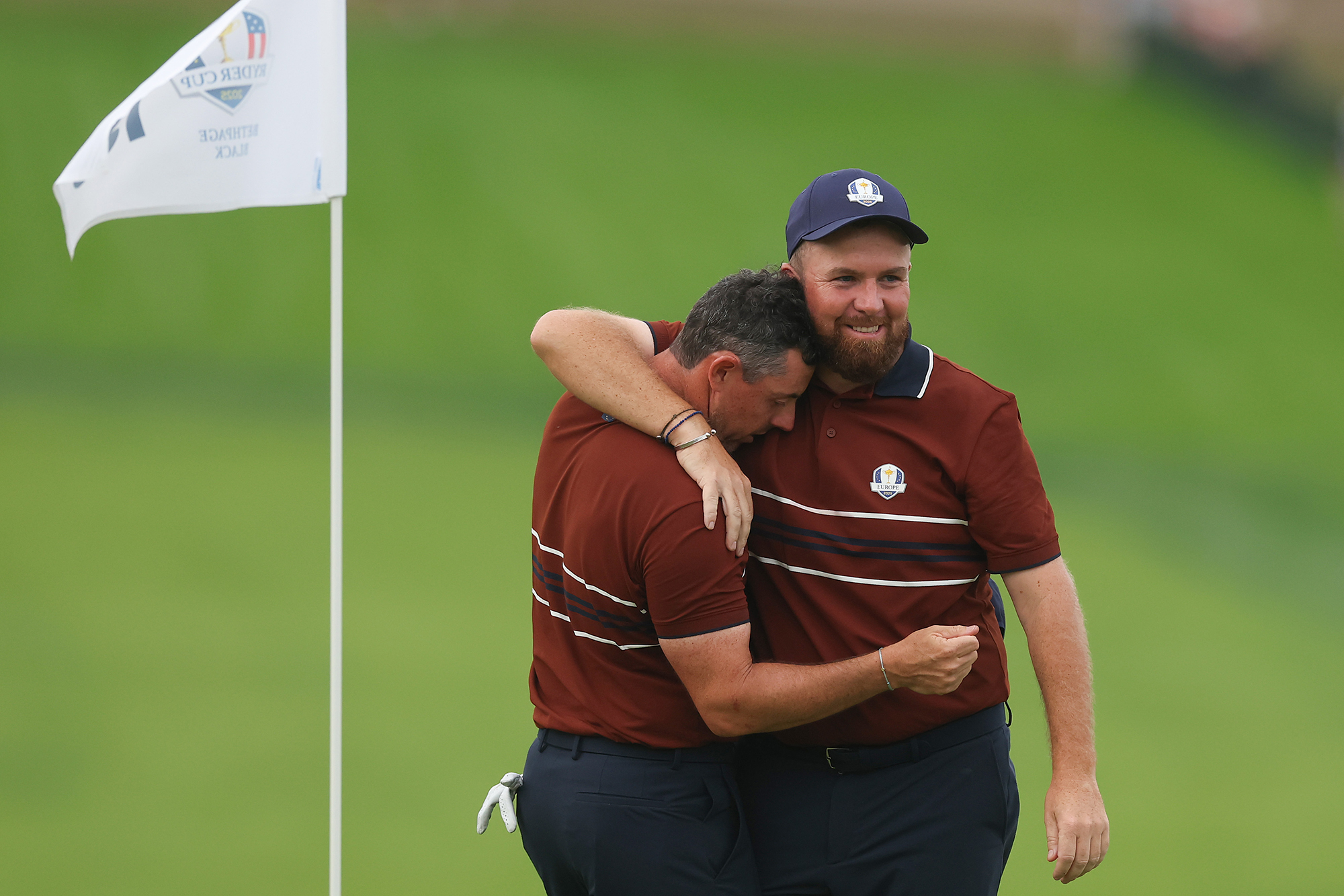 Shane Lowry hugging Rory McIlroy after the pair won their match in the 2025 Ryder Cup at Bethpage Black