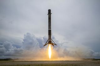 A SpaceX Falcon 9 rocket touches down at Cape Canaveral Space Force Station in Florida after launching the Transporter-2 rideshare mission to orbit, on June 30, 2021.