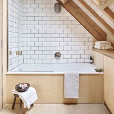Bathroom with blonde wood and white metro wall tiling
