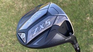 Srixon ZX5 Driver MK II and its silver and black clubhead held aloft on the golf course