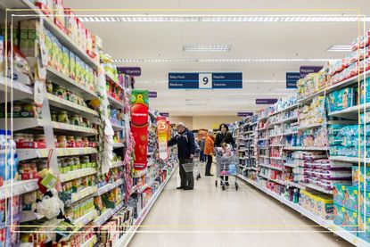 a long shot of a Tesco supermarket aisle which is open on Easter Monday