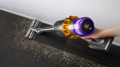 Dyson deal - Dyson V15 Detect cordless vacuum vacuuming mess on gray carpet