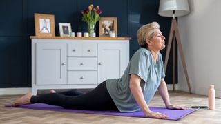 A woman holding the cobra pose in yoga