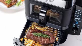 Salter VertiCook air fryer with bottom drawer open to show meat and fries