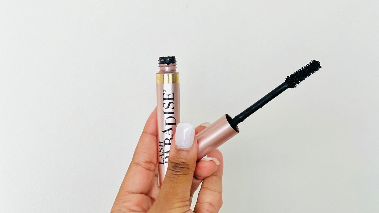 A person holding an opened L'Oreal Lash Paradise mascara for the best L'Oreal mascara.