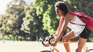Woman cycling through park