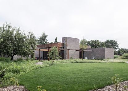 belgian brick bungalow exterior among nature