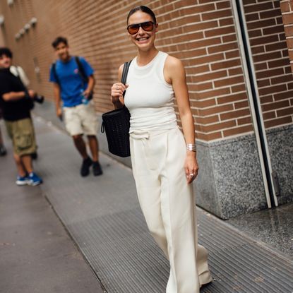 Milan fashion week spring summer 2024 attendee wearing white tank top and pants 