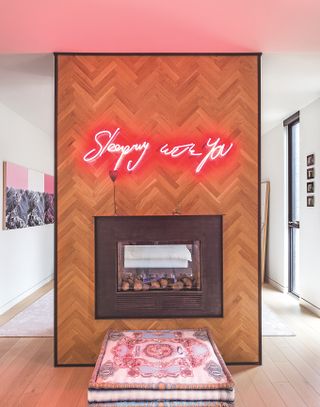 Fireplace with parquet flooring surround and neon light