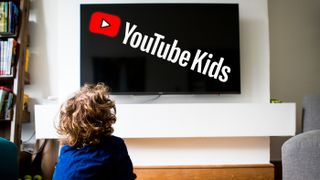 A child watching a TV with YouTube Kids written on it