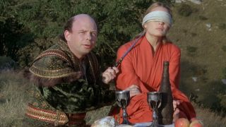 Vizzini holding Buttercup at knifepoint in The Princess Bride