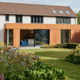 White house with copper Corten steel extension
