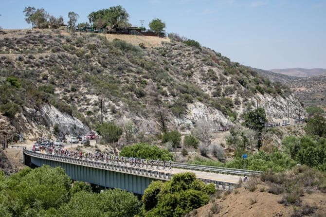 The peloton passes over a bridge after leaving Santa Clarita