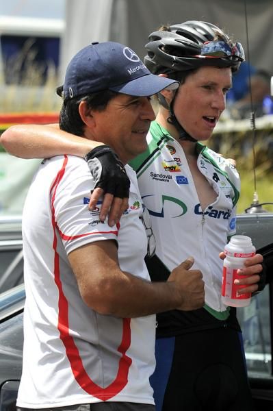 Race organiser Jorge Sandoval congratulates Michael Torkler (Cardno) after winning stage two at the summit of Admiral Hill