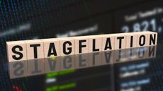 the word "stagflation" spelled out on wooden blocks with stock chart in the background