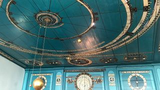 rings of gold sit on a blue background