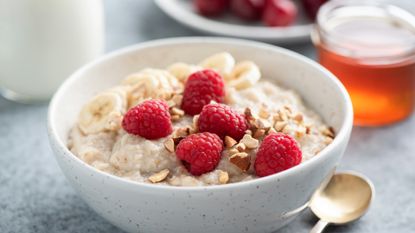 healthy oatmeal breakfast with raspberry and seeds