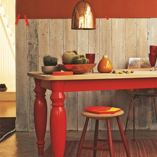 dining room with wooden flooring and orange wall