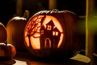 pumpkin carved with house
