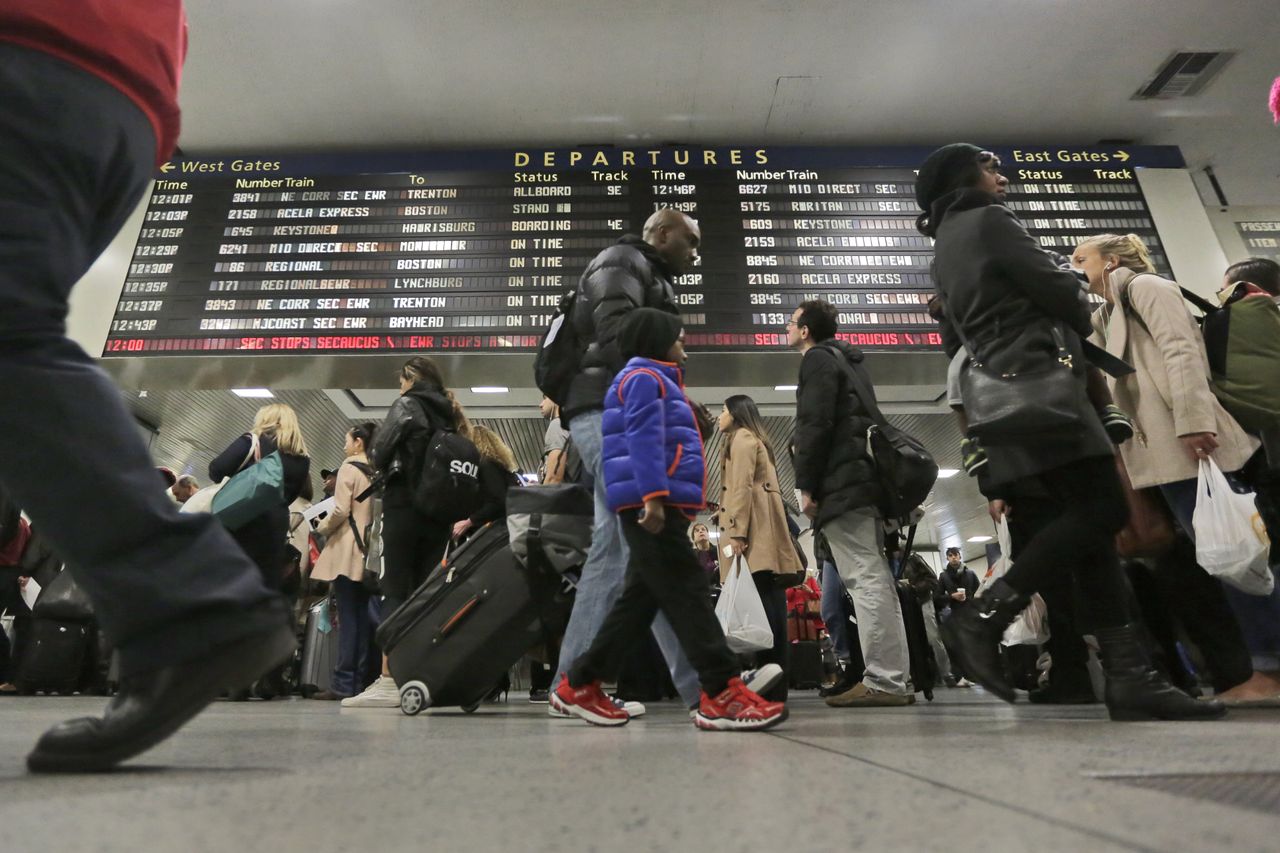 Amtrak travelers pass through New York&amp;#039;s Pennsylvania Station ahead of Thanksgiving Day 2015.