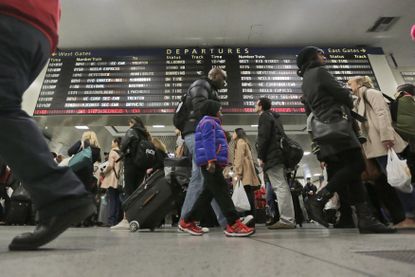 Amtrak travelers pass through New York's Pennsylvania Station ahead of Thanksgiving Day 2015.
