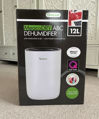 box for MeacoDry ABC Dehumidifier in bedroom with cream carpet on floor