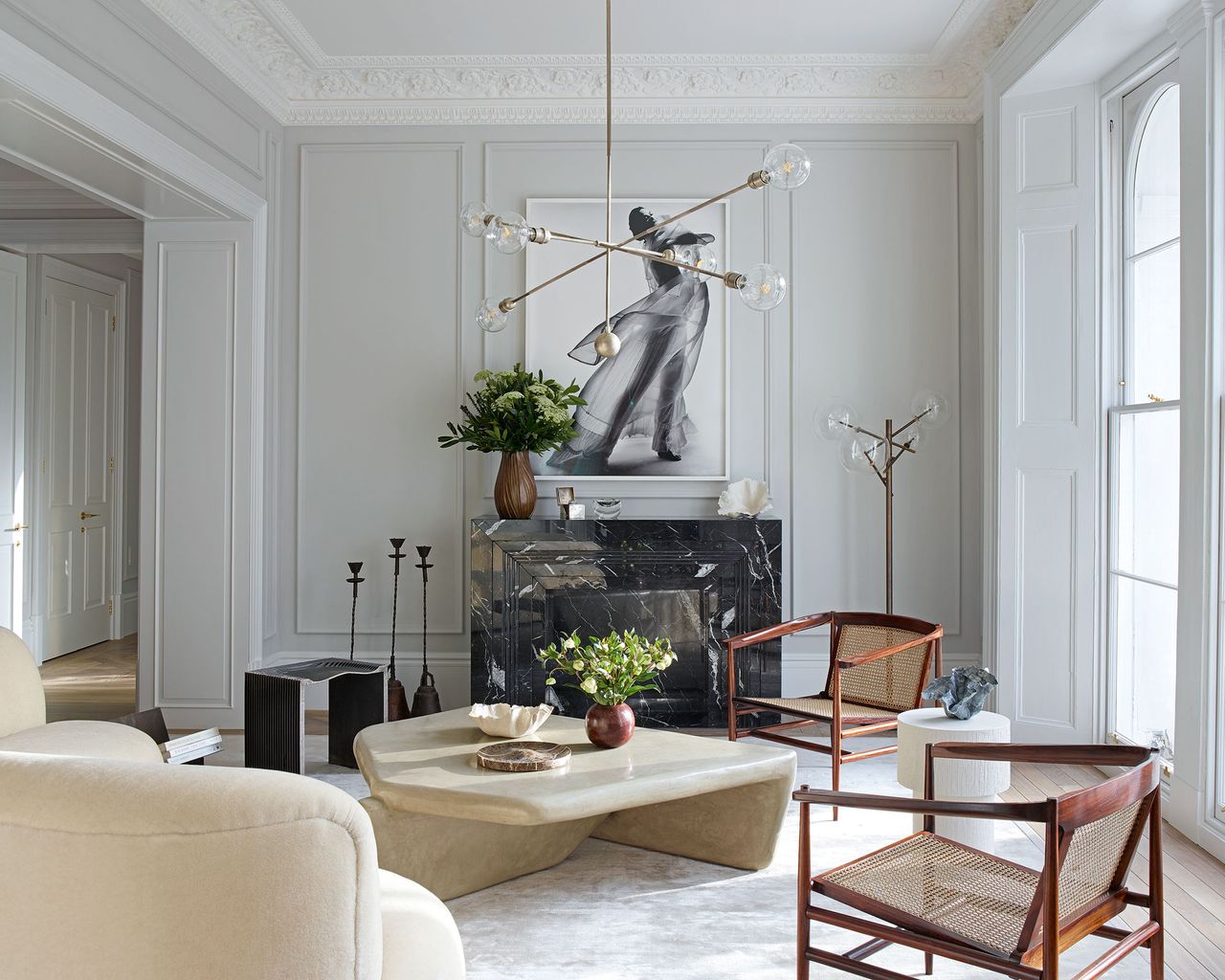 Mass in interior design: White living room with cane and wood chairs