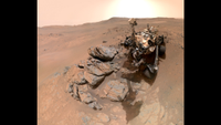 A metal-looking rover with four wheels in an arid, red-brown landscape blah blahblahblahblahblahblahblahblahblahblahblahblahblahblahblahblahblahblahblahblahblahblahblahblahblahblahblahblahblahblahblahblahblahblahblahblahblahblah