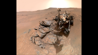 A metal-looking rover with four wheels in an arid, red-brown landscape blah blahblahblahblahblahblahblahblahblahblahblahblahblahblahblahblahblahblahblahblahblahblahblahblahblahblahblahblahblahblahblahblahblahblahblahblahblahblah