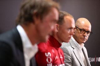 Chris Froome sits between Team Ineos owner Jim Ratcliffe and manager Dave Brailsford