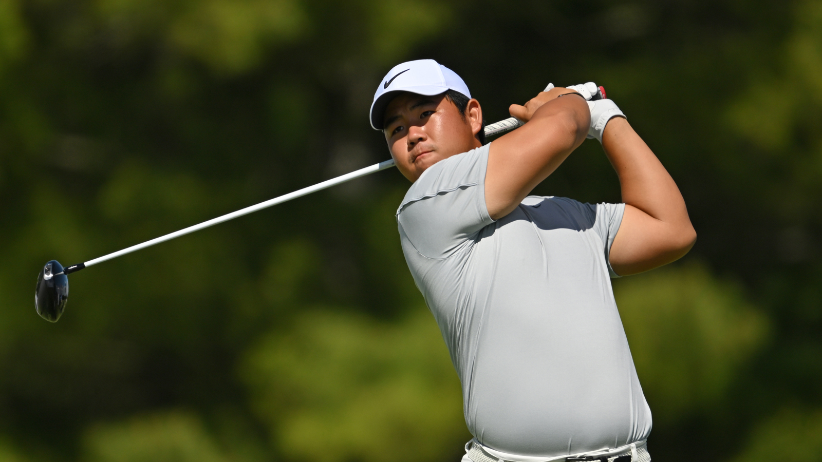 Tom Kim hits a driver off the tee
