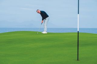 Steve North reading a long putt on the 10th green at Trump Turnberry