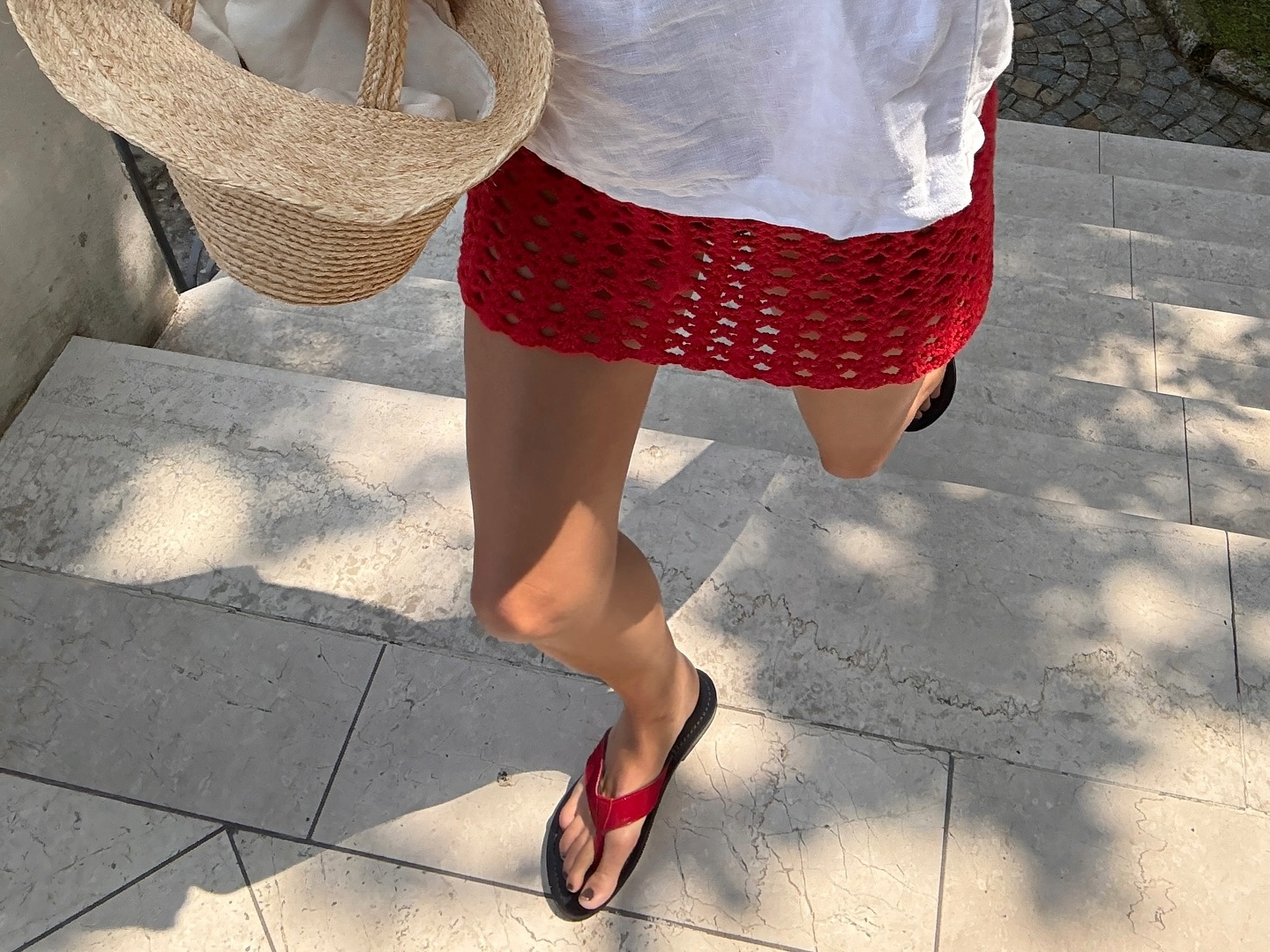 Lucy Williams wears red flip flops at Lake Como.