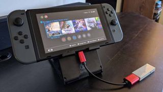 Magic NS adapter plugged into bottom of Switch