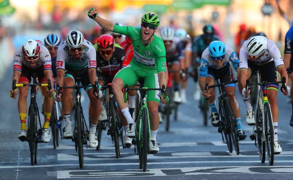 Sam Bennett celebrates winning the final stage in Paris in the green jersey