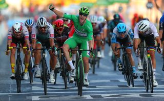 Sam Bennett celebrates winning the final stage in Paris in the green jersey