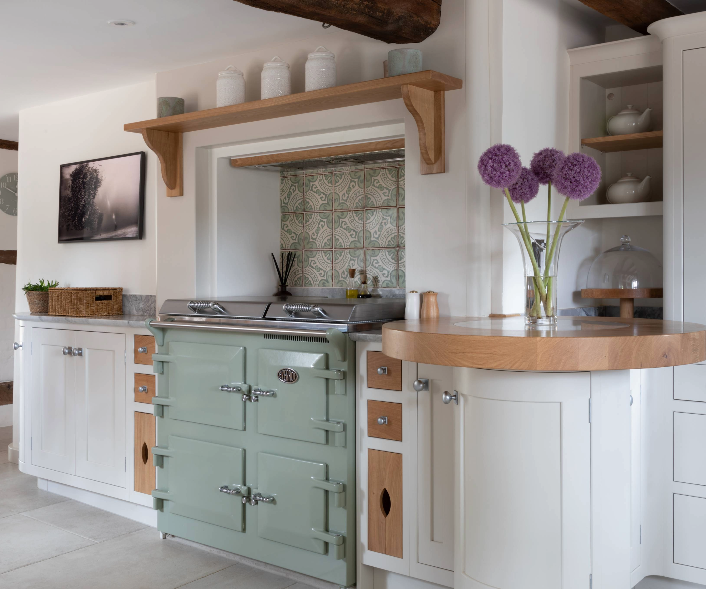 Kitchen with blue/green oven and tiling above