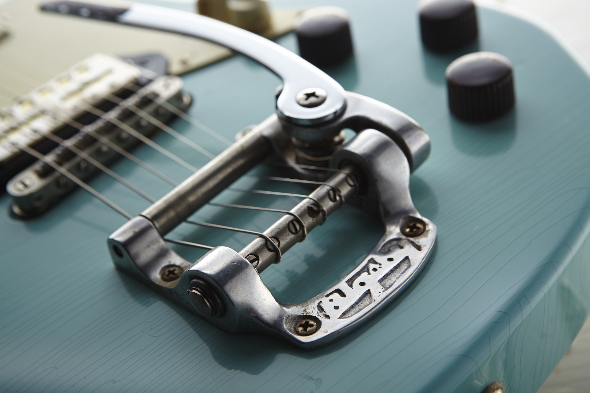 Detail of a Bigsby vibrato on a Chris George Custom electric guitar