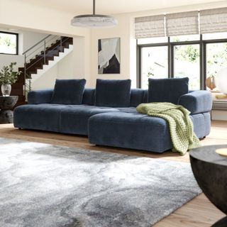 Sofology Flex 3 Seater Chaise sofa in dark blue in a living room