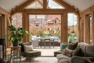 A sitting room with oak beams visible in the roof structure