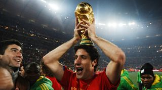 Spain's defender Joan Capdevila raises the trophy as he celebrates winning the 2010 World Cup football final Netherlands vs. Spain on July 11, 2010 at Soccer City stadium in Soweto, suburban Johannesburg. NO PUSH TO MOBILE / MOBILE USE SOLELY WITHIN EDITORIAL ARTICLE - AFP PHOTO / JEWEL SAMAD (Photo credit should read JEWEL SAMAD/AFP via Getty Images)