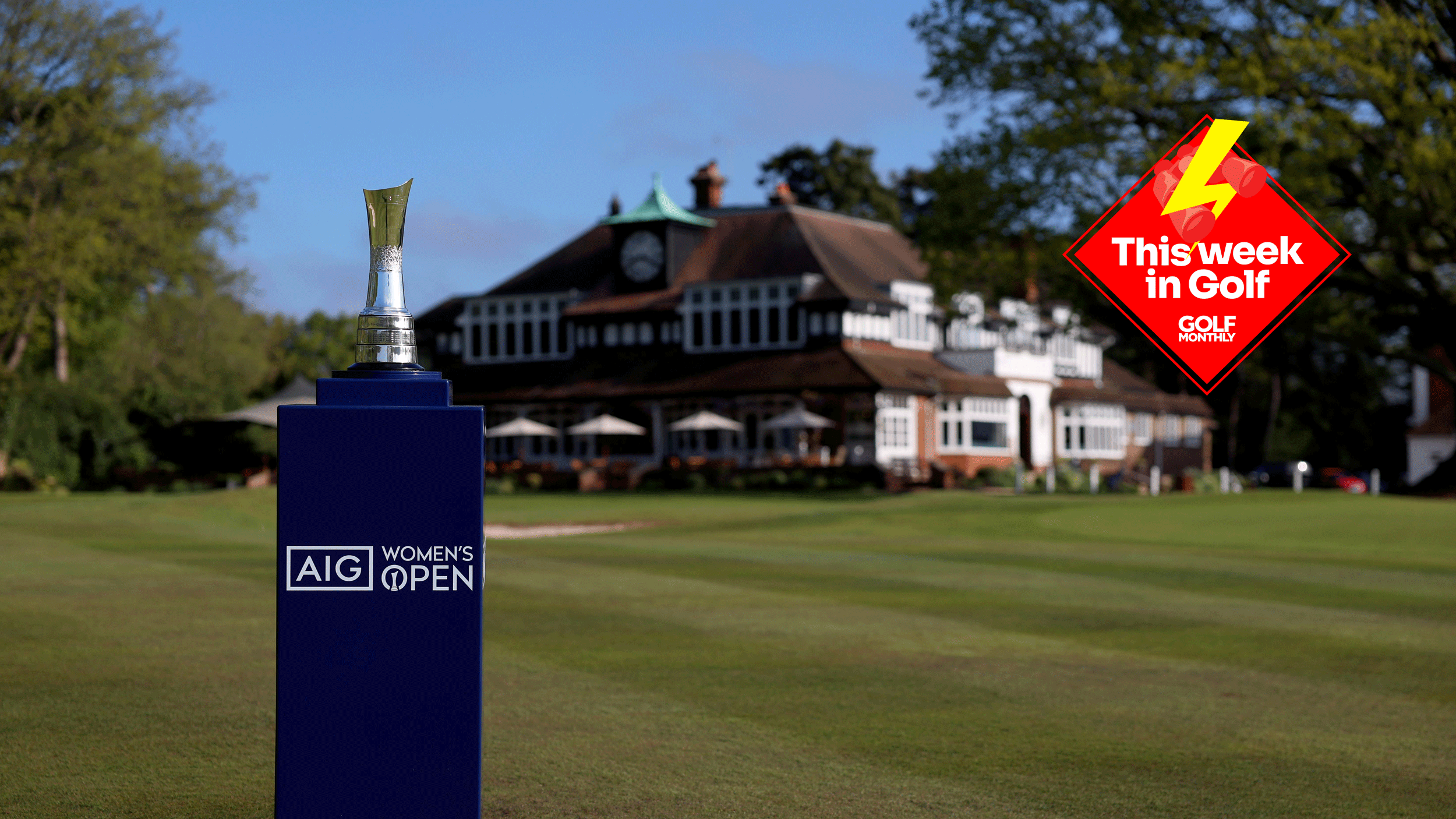 The AIG Women's Open trophy stands in front of Sunningdale Golf Club's club house with a This Week In Golf sticker in the top right