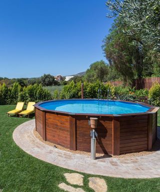 above ground pool on circular paving with lawn