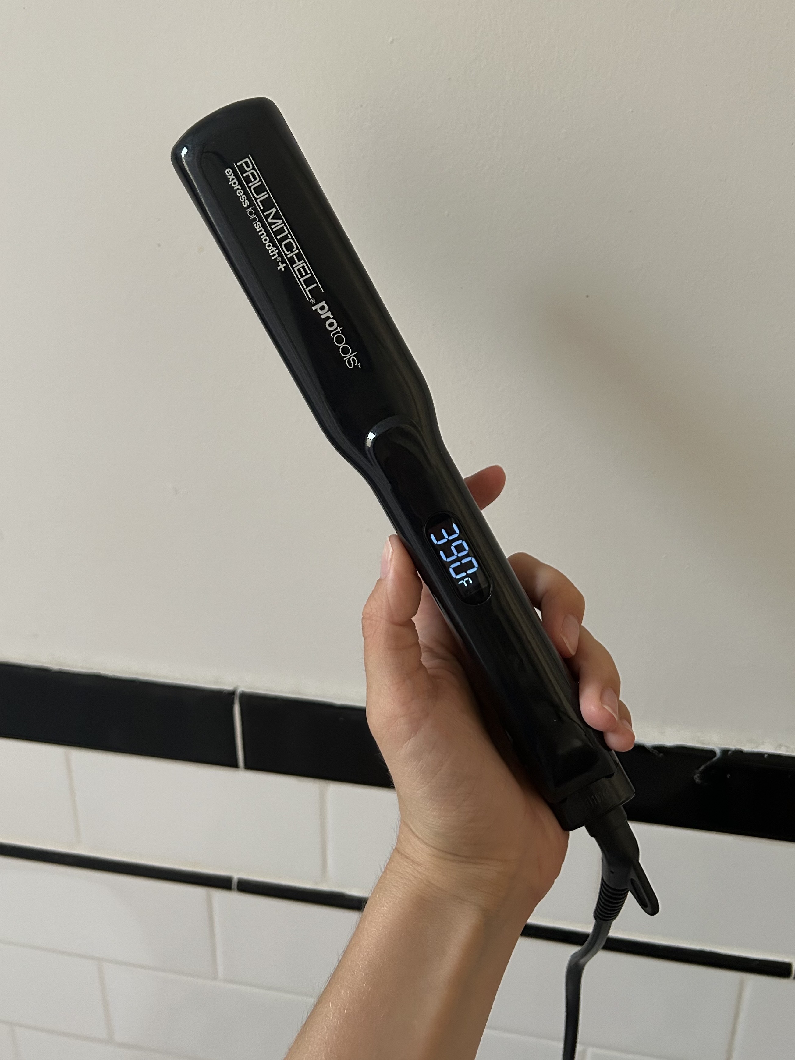 Alyssa Brascia holding the Paul Mitchell Smooth+ Ceramic Flat Iron.