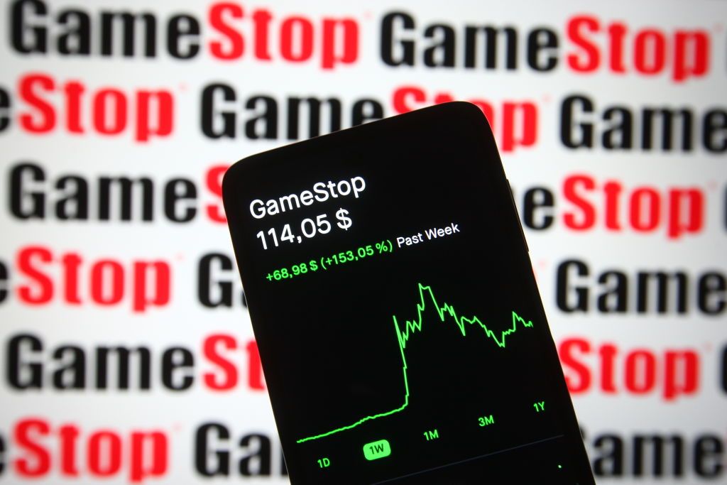 GameStop stock chart on smartphone with GameStop logo in red in black in background