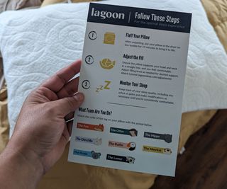 A hand holding the Lagoon Fox Pillow instruction manual above the Lagoon Fox Pillow.