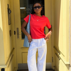 woman wearing ballet flats with white pants summer 2025