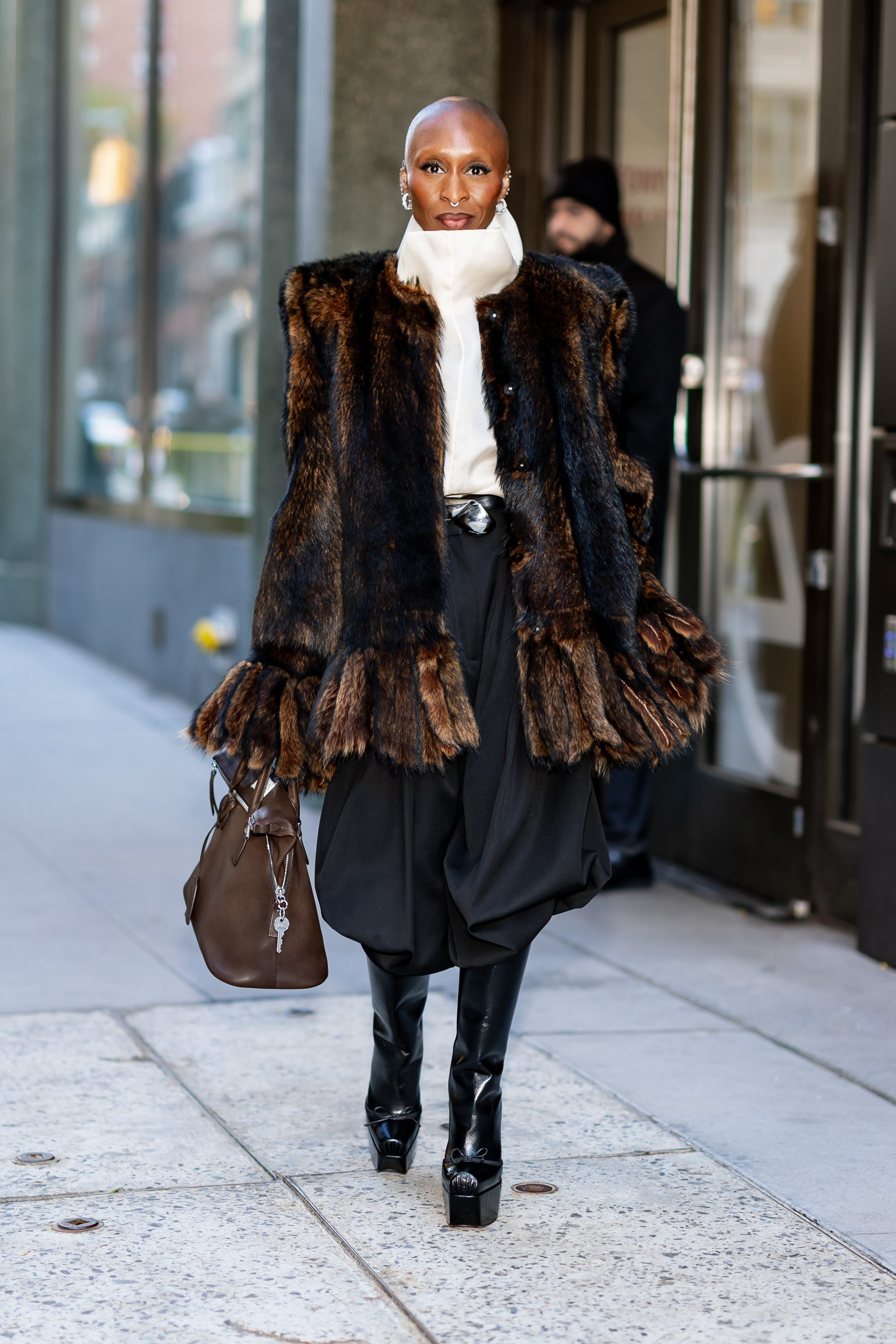 Cynthia Erivo wearing a fur coat and black boots